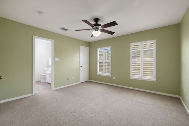 2416 Charleston St Unit E, Houston, TX 77021 - unfurnished bedroom featuring carpet flooring, baseboards, ensuite bath, and ceiling fan