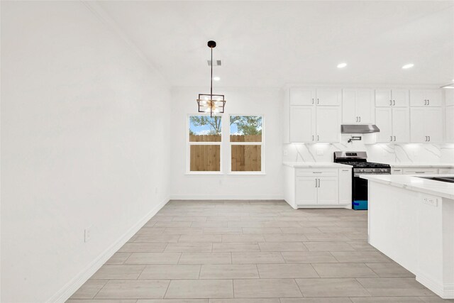 6037 S Acres Dr, Houston, TX 77048 - kitchen with stainless steel gas range oven, under cabinet range hood, a chandelier, white cabinets, and backsplash