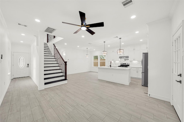 6037 S Acres Dr, Houston, TX 77048 - unfurnished living room with ceiling fan, stairway, recessed lighting, baseboards, and light wood-style flooring
