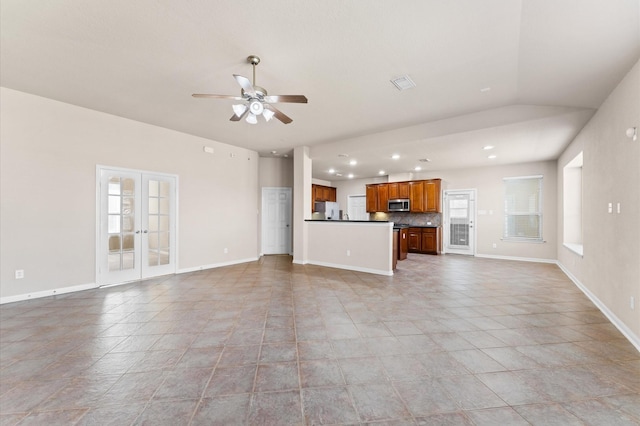 7303 Enchanted Rock Ln, Missouri City, TX 77459 - unfurnished living room featuring healthy amount of natural light, a ceiling fan, recessed lighting, french doors, and baseboards