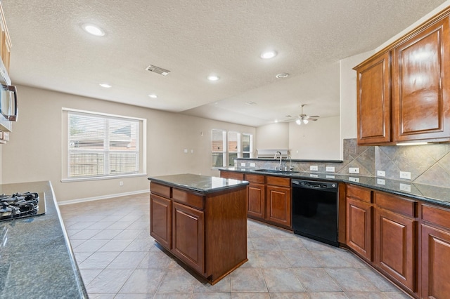 7303 Enchanted Rock Ln, Missouri City, TX 77459 - kitchen with black appliances, a sink, a ceiling fan, backsplash, and a textured ceiling