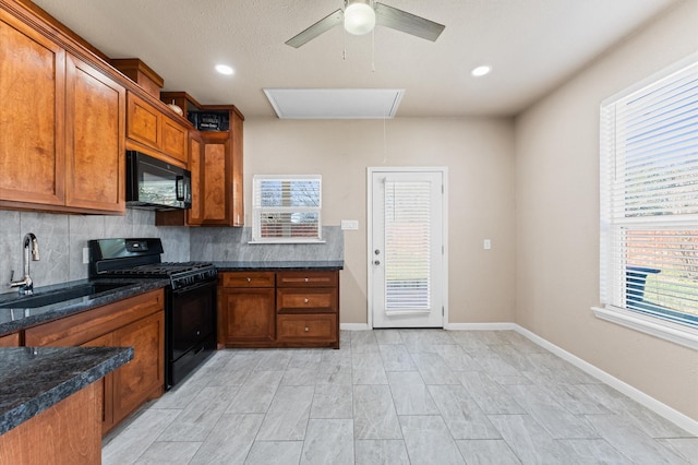 7303 Enchanted Rock Ln, Missouri City, TX 77459 - kitchen featuring black appliances, a sink, ceiling fan, tasteful backsplash, and brown cabinets
