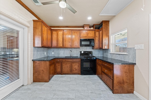 7303 Enchanted Rock Ln, Missouri City, TX 77459 - kitchen featuring black appliances, brown cabinetry, and backsplash