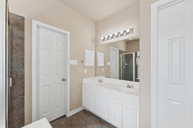 7303 Enchanted Rock Ln, Missouri City, TX 77459 - bathroom featuring a shower stall, tile patterned floors, and double vanity