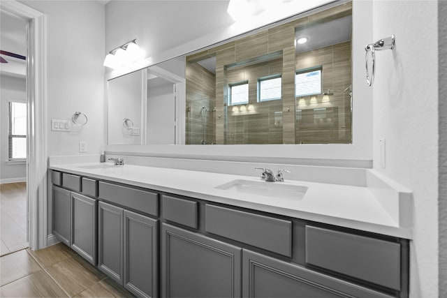4325 Victoria Pine Dr, Spring, TX 77386 - bathroom featuring a shower stall, double vanity, tile patterned floors, and baseboards