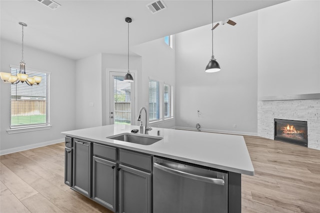 4325 Victoria Pine Dr, Spring, TX 77386 - kitchen with dishwasher, a sink, open floor plan, gray cabinetry, and light wood finished floors