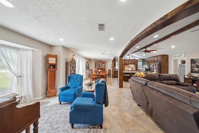 96 Fm 2550th Rd, Huntsville, TX 77320 - living room featuring arched walkways, recessed lighting, ceiling fan, a textured ceiling, and baseboards