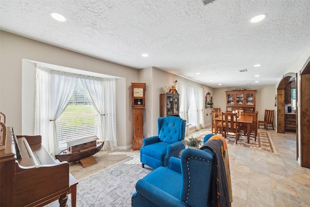 96 Fm 2550th Rd, Huntsville, TX 77320 - living room with arched walkways, plenty of natural light, recessed lighting, a textured ceiling, and baseboards