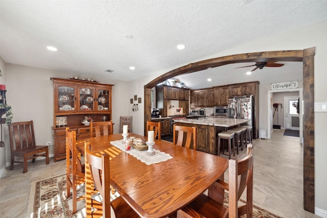 96 Fm 2550th Rd, Huntsville, TX 77320 - dining area with a ceiling fan, arched walkways, recessed lighting, baseboards, and a textured ceiling