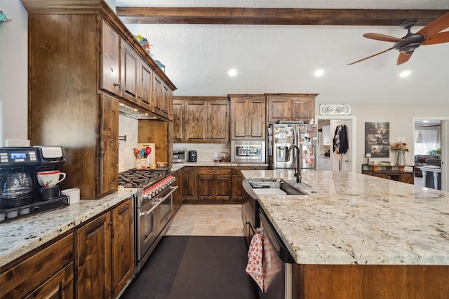 96 Fm 2550th Rd, Huntsville, TX 77320 - kitchen featuring appliances with stainless steel finishes, a sink, light stone counters, a ceiling fan, and recessed lighting