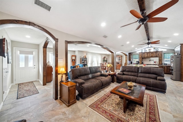 96 Fm 2550th Rd, Huntsville, TX 77320 - living area featuring arched walkways, vaulted ceiling, plenty of natural light, ceiling fan, and recessed lighting