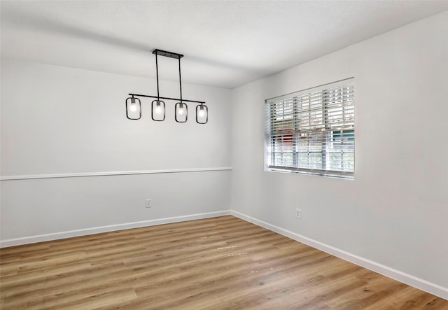 5524 Beverlyhill St Unit 4, Houston, TX 77056 - unfurnished dining area featuring baseboards and light wood-type flooring