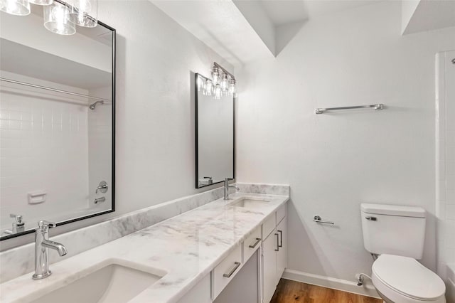 5524 Beverlyhill St Unit 4, Houston, TX 77056 - full bathroom featuring toilet, wood finished floors, double vanity, and baseboards
