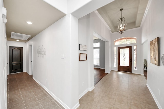15122 Heron Meadow Ln, Cypress, TX 77429 - entrance foyer with light tile patterned flooring, a high ceiling, a raised ceiling, baseboards, and a chandelier