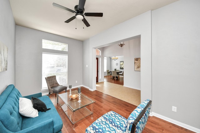 15122 Heron Meadow Ln, Cypress, TX 77429 - living area with a chandelier, wood finished floors, a ceiling fan, and baseboards