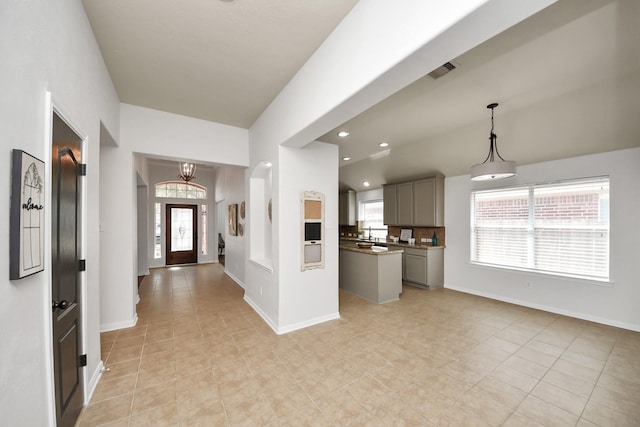 15122 Heron Meadow Ln, Cypress, TX 77429 - kitchen with gray cabinets, a chandelier, light tile patterned flooring, baseboards, and open floor plan