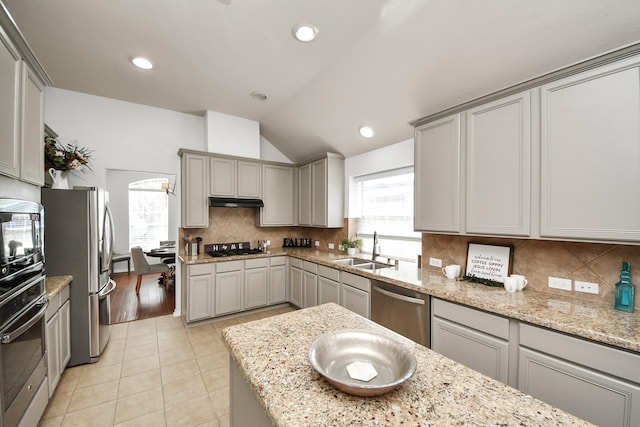 15122 Heron Meadow Ln, Cypress, TX 77429 - kitchen with a sink, stainless steel appliances, gray cabinetry, vaulted ceiling, and recessed lighting