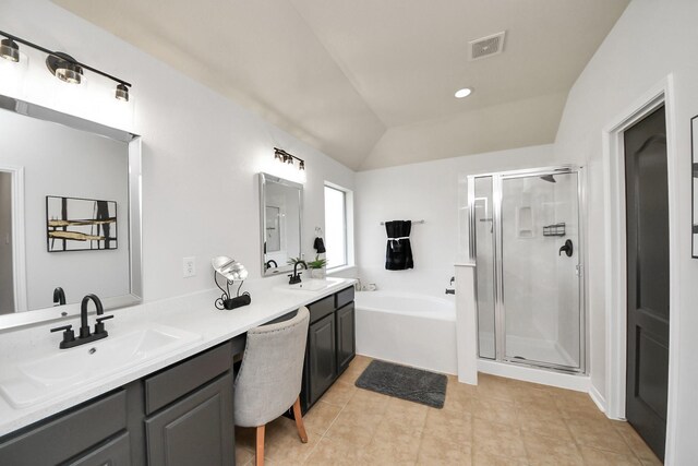 15122 Heron Meadow Ln, Cypress, TX 77429 - bathroom with a stall shower, a garden tub, double vanity, tile patterned flooring, and lofted ceiling