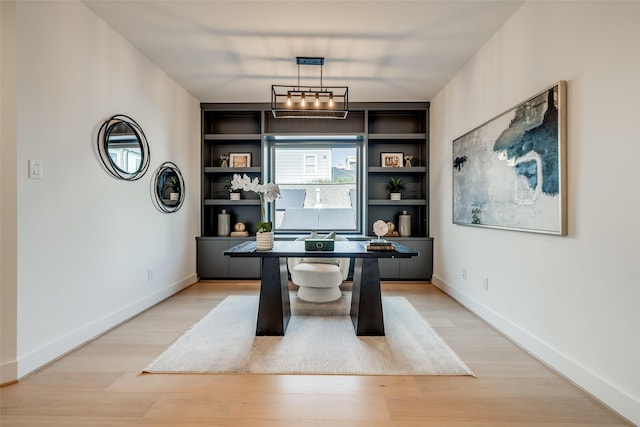 1209 W Bell St, Houston, TX 77019 - office area with light wood-type flooring, baseboards, and built in shelves