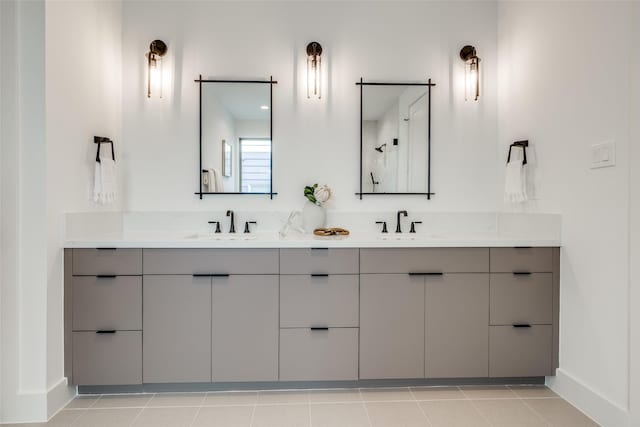 1209 W Bell St, Houston, TX 77019 - bathroom featuring baseboards, double vanity, and tile patterned floors