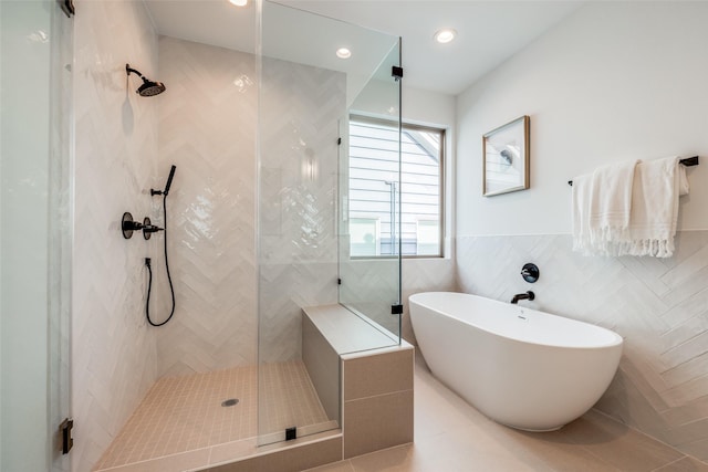 1209 W Bell St, Houston, TX 77019 - bathroom with tiled shower, a soaking tub, tile patterned flooring, tile walls, and recessed lighting