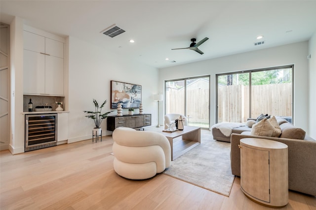 1209 W Bell St, Houston, TX 77019 - living area featuring beverage cooler, a bar, light wood finished floors, ceiling fan, and recessed lighting