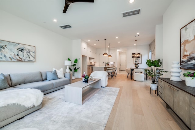 1209 W Bell St, Houston, TX 77019 - living area with light wood-style flooring and recessed lighting