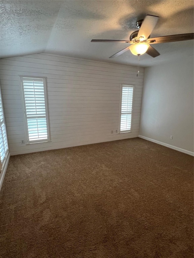 4326 Holly Terrace Ct, Pasadena, TX 77505 - empty room featuring a textured ceiling, ceiling fan, lofted ceiling, carpet, and baseboards