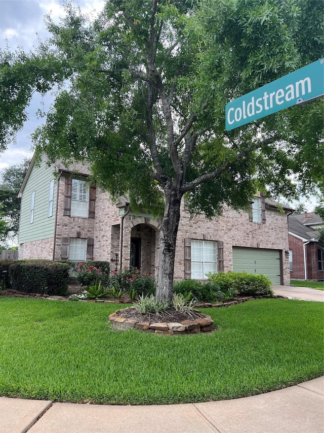 4326 Holly Terrace Ct, Pasadena, TX 77505 - obstructed view of property with brick siding, a garage, a front yard, and driveway