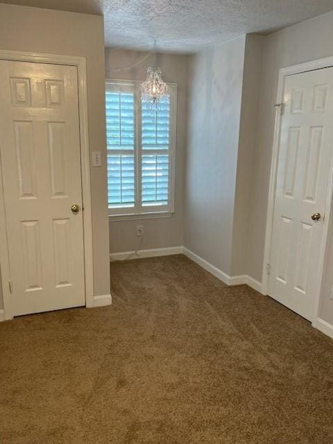4326 Holly Terrace Ct, Pasadena, TX 77505 - carpeted empty room featuring a textured ceiling, a chandelier, and baseboards