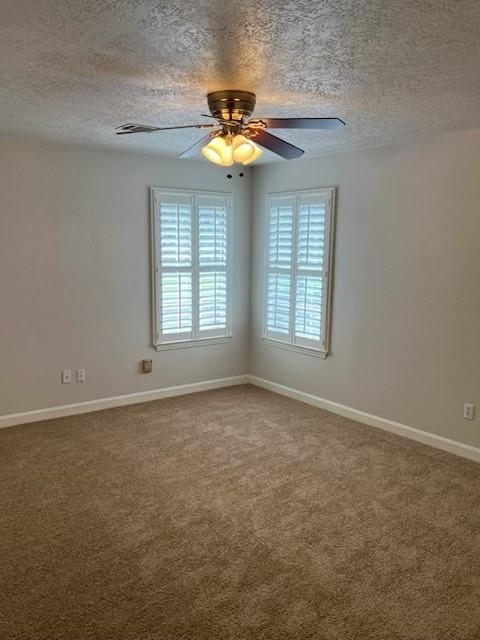 4326 Holly Terrace Ct, Pasadena, TX 77505 - spare room with a textured ceiling, carpet floors, baseboards, and ceiling fan