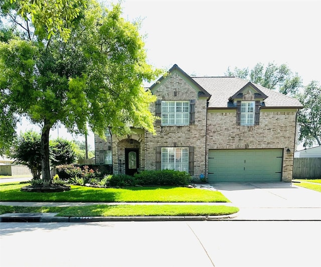 4326 Holly Terrace Ct, Pasadena, TX 77505 - view of front of house featuring driveway, a front lawn, an attached garage, and brick siding