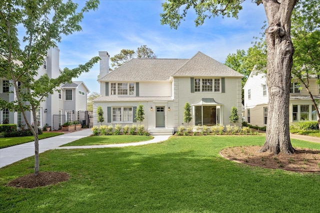 2518 Glen Haven Blvd, Houston, TX 77030 - view of front of property featuring a chimney, a front yard, and a shingled roof