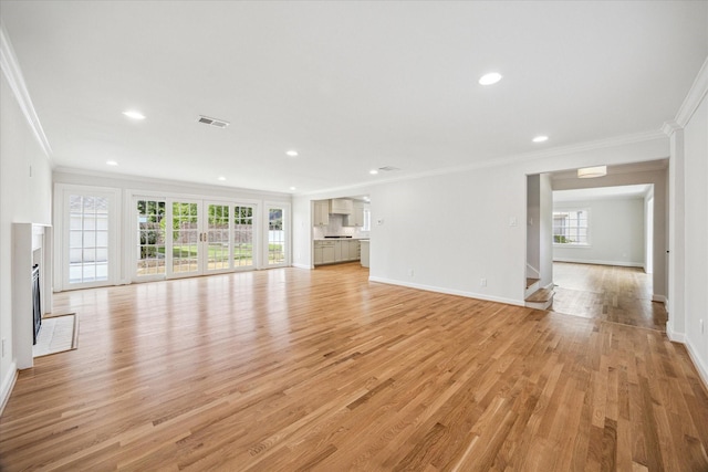 2518 Glen Haven Blvd, Houston, TX 77030 - unfurnished living room with crown molding, healthy amount of natural light, light wood finished floors, baseboards, and recessed lighting