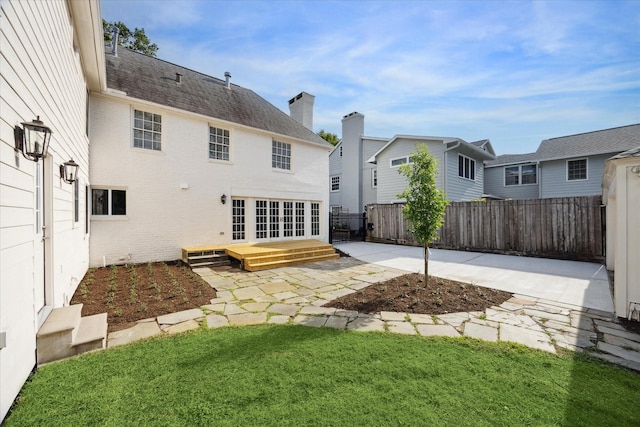 2518 Glen Haven Blvd, Houston, TX 77030 - back of property featuring a patio area, brick siding, a chimney, and a shingled roof