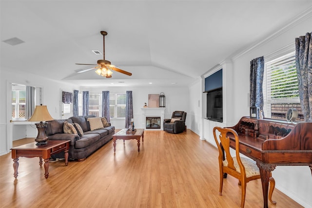 606 Packer Ct, Webster, TX 77598 - living room with ceiling fan, light wood finished floors, plenty of natural light, lofted ceiling, and crown molding