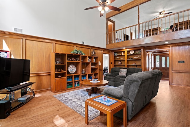 6207 Spring Creek Oaks Dr, Spring, TX 77379 - living room featuring a ceiling fan, a high ceiling, and light wood-style flooring