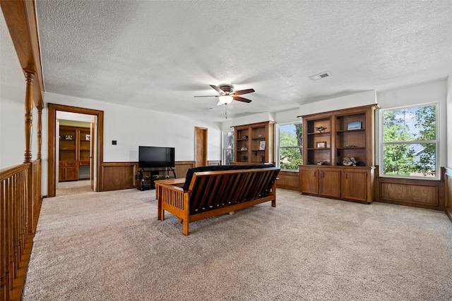 6207 Spring Creek Oaks Dr, Spring, TX 77379 - living room with healthy amount of natural light, light colored carpet, a desk, wainscoting, and a textured ceiling