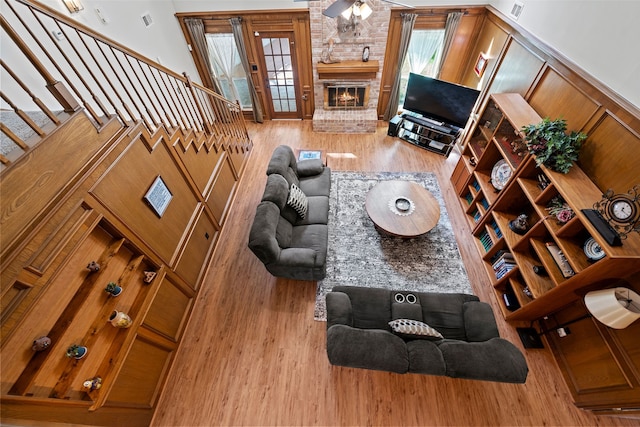 6207 Spring Creek Oaks Dr, Spring, TX 77379 - living area with wood finished floors, a fireplace, stairs, and ceiling fan