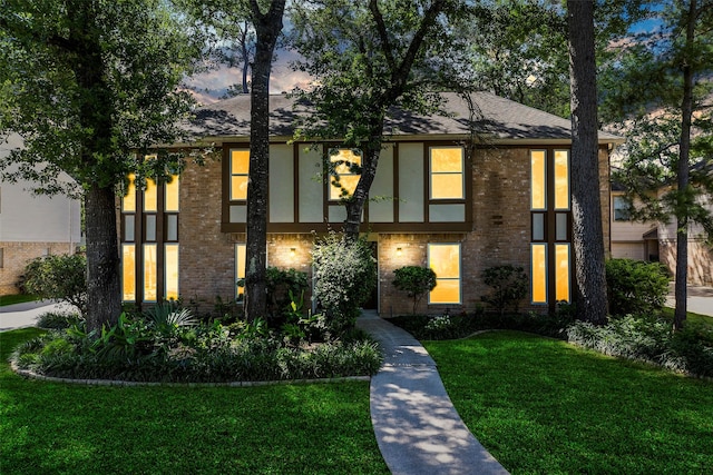6207 Spring Creek Oaks Dr, Spring, TX 77379 - view of front of house with a yard, brick siding, stucco siding, and a shingled roof