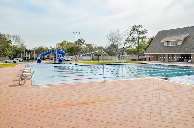 6207 Spring Creek Oaks Dr, Spring, TX 77379 - community pool featuring a water slide, fence, and a patio area