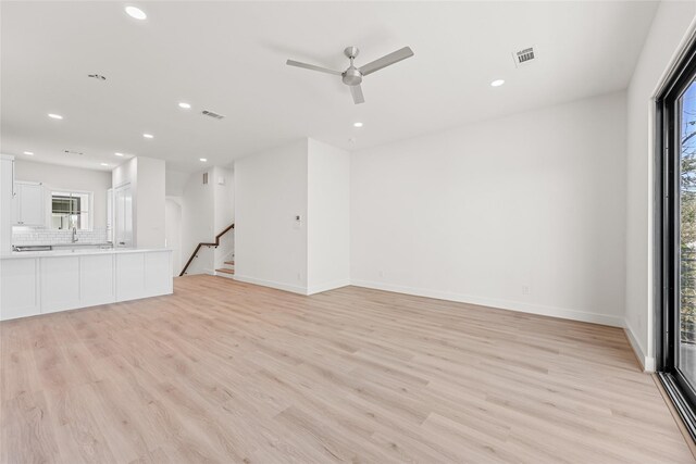 1511 Vermont St Unit A, Houston, TX 77006 - unfurnished living room featuring light wood-style flooring, recessed lighting, a ceiling fan, baseboards, and stairs