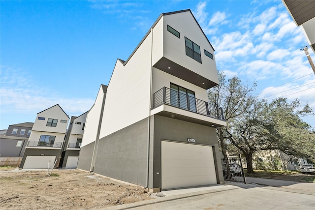 1511 Vermont St Unit A, Houston, TX 77006 - view of front of home featuring a balcony, a garage, and concrete driveway