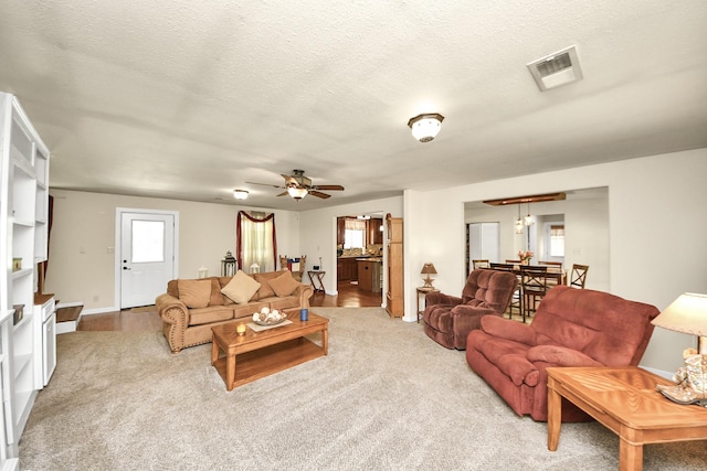 1576 Belle Terre Rd, Huffman, TX 77336 - carpeted living room featuring a ceiling fan, a textured ceiling, and baseboards