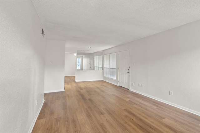 1516 Bay Area Blvd Unit Q1, Houston, TX 77058 - spare room with a textured ceiling, light wood-style flooring, and baseboards
