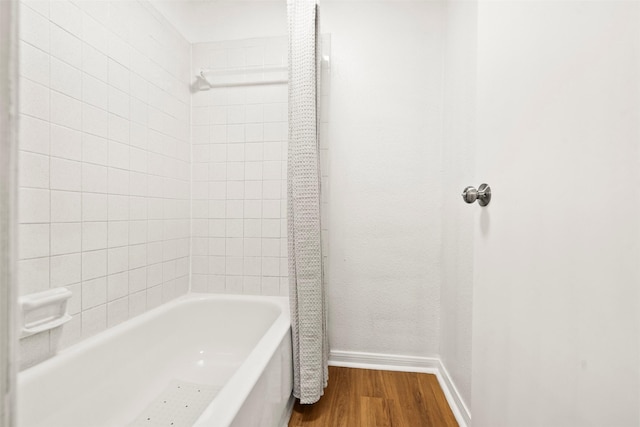 1516 Bay Area Blvd Unit Q1, Houston, TX 77058 - bathroom featuring wood finished floors, baseboards, and  shower combination