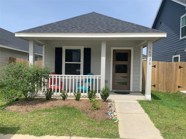 16520 Jasmine Marie Pl, Conroe, TX 77306 - view of exterior entry with a porch and roof with shingles