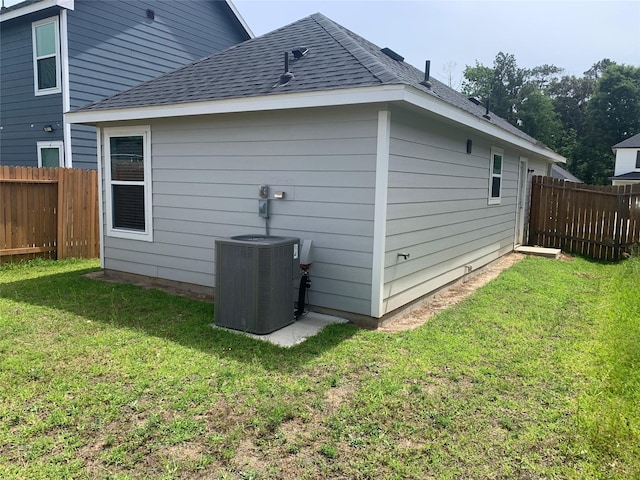 16520 Jasmine Marie Pl, Conroe, TX 77306 - back of house featuring central AC unit and roof with shingles