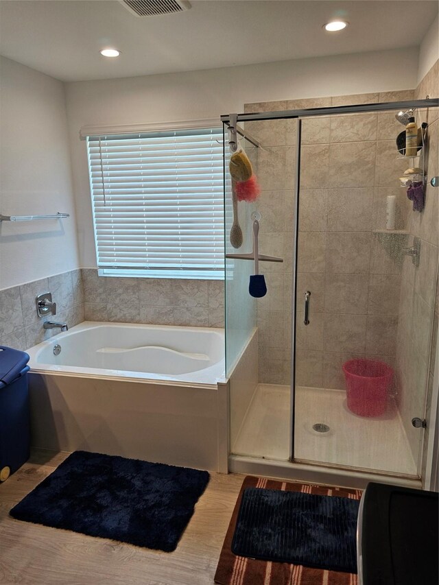 1307 Ricasoli Dr, Richmond, TX 77406 - full bath featuring a bath, a shower stall, recessed lighting, and wood finished floors