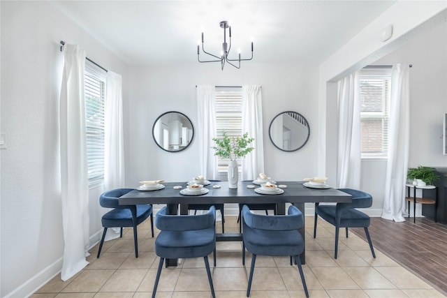 8926 Rollick Dr, Tomball, TX 77375 - dining space featuring a chandelier, baseboards, and light tile patterned flooring